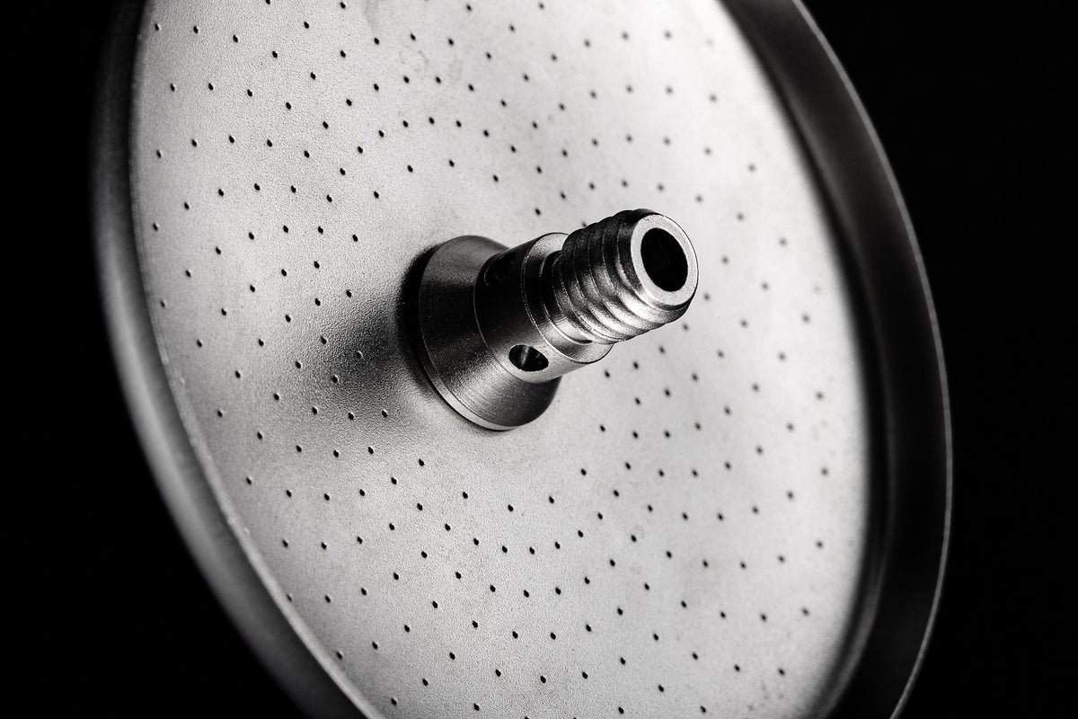 Laser-perforated face of an IMS Laser Brew shower screen with integrated screw
